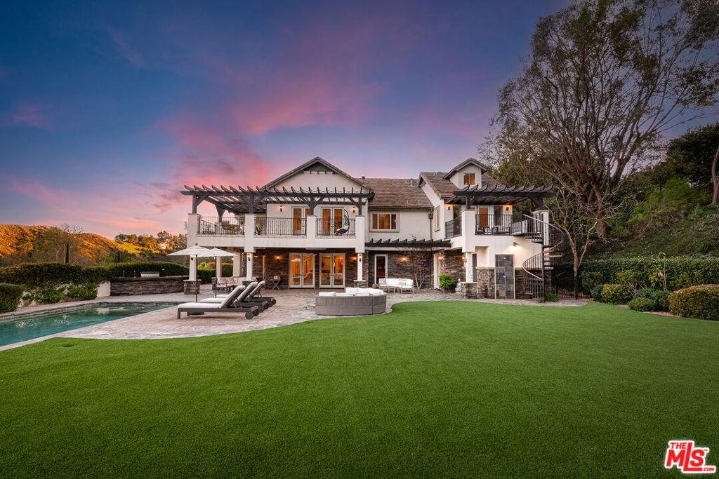Located in the prestigious gated enclave of Park South Estates, this extraordinary 9,200 sq. ft. Tuscan-inspired estate offers unparalleled luxury and sophistication. Fully renovated and set on over three acres at the end of a tranquil cul-de-sac, this six-bedroom, nine-bathroom masterpiece boasts nearly one acre of lush, flat land with breathtaking vineyard and mountain views.A grand two-story foyer with a sweeping staircase sets the stage for the elegance within. Travertine and hardwood floors, four fireplaces, and impeccable craftsmanship define the interiors.Entertainment abounds with an oversized home theater for a true cinematic experience and a spacious upstairs recreation roomideal for a game room or home office. The chef's kitchen has been recently remodeled with custom cabinetry, marble countertops, Viking and Frigidaire appliances, and a large center island, perfect for culinary enthusiasts.Designed for grand-scale entertaining, the outdoor oasis features a custom saltwater pool and spa, full outdoor kitchen, fire pit, expansive grassy play area, and multiple covered terraces with ceiling fans and heaters. The serene backdrop of vineyards and twinkling city lights evokes the ambiance of Napa or Tuscany.The primary suite is a luxurious retreat, offering wraparound balconies, a fireplace, dual walk-in closets, a bar refrigerator, and a spa-inspired bath with a steam room, multiple showers, an indoor jacuzzi, a massage area, and a gymplus an additional private outdoor balcony.A separate guest wing functions as an independent guest house, complete with its own fireplace and French doors leading to the pool and spa. The family room, designed for both relaxation and entertaining, features a walk-in wet bar and beverage closet.Modern upgrades include a brand-new, energy-efficient seven-zone heating and cooling system, ensuring year-round comfort. Walls of French doors seamlessly blend indoor and outdoor living, opening to beautifully landscaped gardens.Situated minutes from Malibu Canyon and Mulholland, this exceptional estate provides effortless access to both Malibu and Calabasas. It is also conveniently located near premier shopping at Topanga Social Village and The Commons at Calabasas, the highly anticipated new Rams practice facility, and award-winning public and private schools.Experience the ultimate in luxury, privacy, and serenity in this breathtaking Calabasas estate.