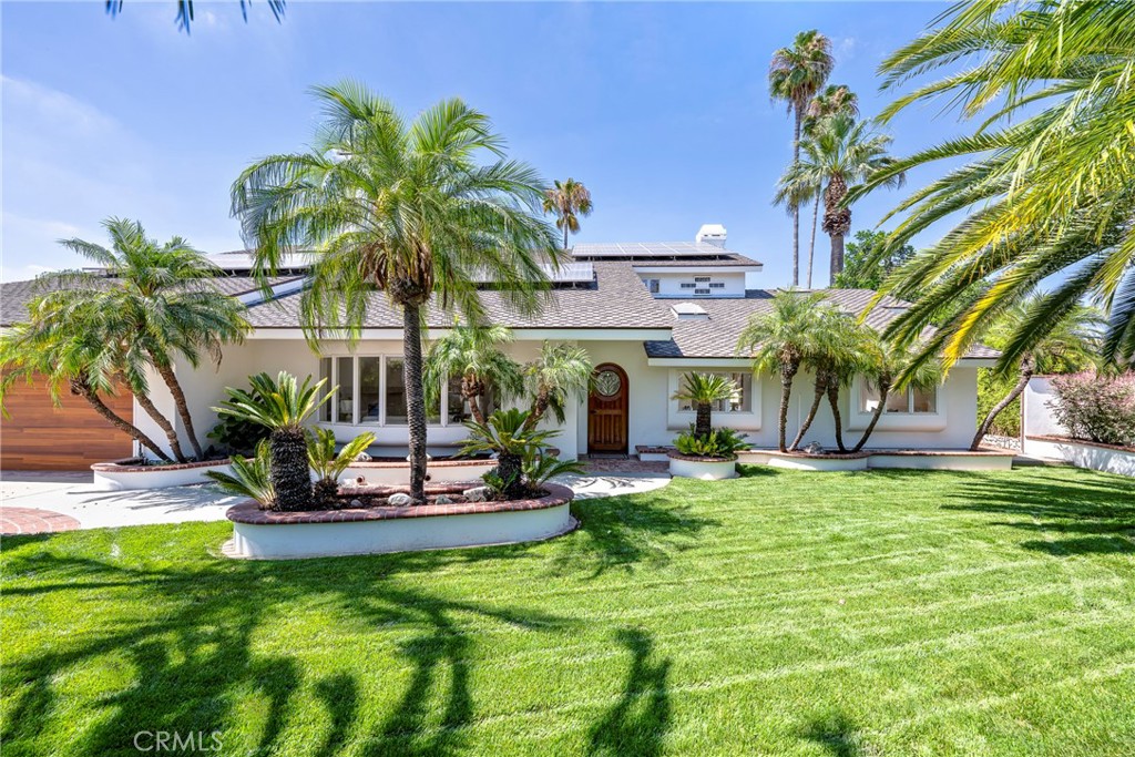 If you’ve reached the point in life where it’s time to elevate your primary residence, welcome to the perfect destination. This expansive, Las Palmas Estate has been thoughtfully designed and meticulously updated to offer a lifestyle of elegance, comfort, and distinction.
Soaring vaulted ceilings, custom windows and doors flood the four bedroom, two bath home with natural light, creating a grand, yet inviting atmosphere. Designer finishes throughout include imported Absolute Black Granite tile, limestone tile, European hardwoods from France, distressed maple wood flooring, and Bird’s Eye Maple cabinetry — each detail curated for timeless appeal. The home also features four designer fireplaces, each with its own unique character: marble hearths, imported stone trim, and a backlit stone mantel.
Indoor and outdoor living seamlessly blend thanks to a La Cantina custom folding door system that opens fully to reveal unobstructed views of your backyard oasis. Set on just under one-third of an acre, the sprawling, landscaped grounds have reinforced concrete walls for added privacy and security. The backyard features lush lawns, mature tropical palms, a terraced design, a large pool with diving board, and multiple entertainment areas perfect for gatherings or serene relaxation.
Function meets beauty with comprehensive system upgrades, including dual-zone central heating and air conditioning, a tankless water heater, a solar energy system, and an insulated garage door. Car enthusiasts will appreciate the finished five-car garage, ideal for both daily drivers and collector vehicles.
This is more than a home — it’s a statement. Come see how life is a little brighter on Sunny Hills Road in this elevated Las Palmas Estate.