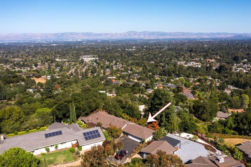 Nestled in a serene cul-de-sac setting with mountain views, just outside the Village of Saratoga offering 3-bedrooms, 2.5 bath, Ranch Style home, thoughtfully designed home. As you step inside, you'll be welcomed by an inviting floorplan that encourages both relaxation and entertainment.The spacious living areas are accentuated by large windows throughout that frame picturesque mature trees and Silicon Vallley views, creating a seamless connection with the outdoors. Gourmet kitchen opens into the family room perfect for culinary adventures and gatherings with views of the expansive decking. The formal dining room is perfect for the holiday and group entertainment. Its proximity to the vibrant village of Saratoga ensures easy access to local shops, dining, and community events. Easy access to the major corporations of Silicon Valley.This residence is a private retreat offering a perfect balance of convenience and serene living.  Saratoga Excellent Schools.  VIEWS!