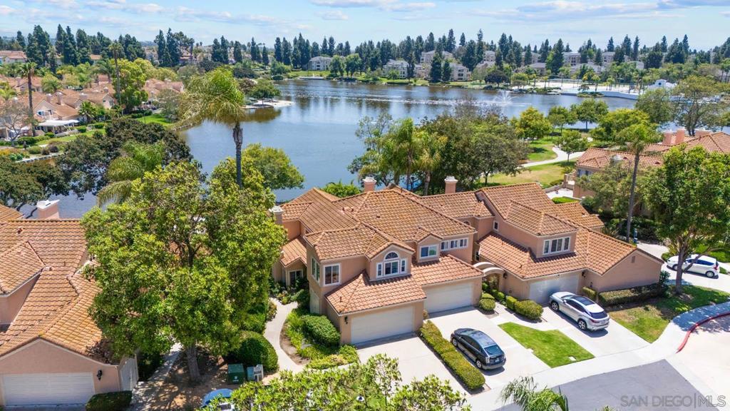 Step out to the lake right from your back patio or enjoy sunsets from your main bedroom deck. Luxurious master with walk in closet. Only unit with built in corner desk with built in book shelf in 2nd bedroom, The cozy fireplace for relaxation and comfort. Immaculate beautiful home is a must see. Rare to find a home directly on the lake. Access to clubhouse and 5 swimming pools to choose from. Only home directly on the lake. This is a must see.