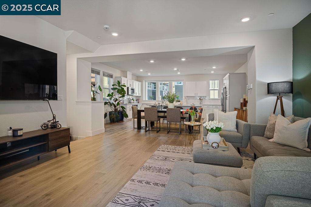 OPEN SAT 8/23 FROM 2PM-5PM! Modern living meets convenience at The Hideaway. This 4BR/3.5BA townhome offers 1,969 sq. ft. of bright, low-maintenance living with minimal shared walls and no backyard upkeep—ideal for today’s active lifestyle. The entry level features a private in-law suite with full bath, perfect for guests or multi-gen living. On the main level, the open-concept great room connects the kitchen, dining, and living areas, highlighted by large windows and a private balcony with views. The gourmet kitchen includes an oversized quartz island, stainless appliances, and ample storage. Upstairs, the primary suite offers a spa-like bath with dual sinks, walk-in shower, and spacious closet, plus two additional bedrooms and laundry. Upgrades include smart home features and paid solar. Community amenities include BBQ areas, bocce, walking trails, and a dog wash station. A private, low-maintenance lifestyle just minutes from BART, Cal State East Bay, and major freeways.