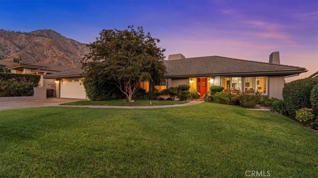 This contemporary ranch-style residence presents an inviting blend of timeless design & modern convenience, creating a home that feels both open & intimate. Designed on a single level, it offers approximately 2,713 square feet of living space with four bedrooms, three & one-half bathrooms, & a seamless indoor-outdoor flow that makes every day feel effortless. The great room draws your attention outward from the moment you enter through the front door. Expansive picture windows frame views of the surrounding canyon & foothills. Natural light pours into the home & across hardwood floors that transport you from room to room. The fireplace establishes a cozy atmosphere as the season begins to change. Vaulted ceilings enhance the sense of volume & ease. The kitchen is equipped with granite countertops, stainless steel appliances, & custom cabinetry that maximizes storage without sacrificing style. A sun-filled breakfast nook creates a natural place to begin the day, while the family room opens through sliding glass doors to the patio & pool, extending your living space outdoors. The primary suite is a true retreat. The dual closets provide generous storage, & the spa-inspired bath features a soaking tub, separate shower, & direct access to the backyard, allowing a quiet transition from rest to relaxation. The secondary bedrooms are equally well designed, each with ample closet space, & one enjoys an en-suite bath ideal for guests or extended family. Outdoors, the property delivers on California living. A sparkling pool & spa promise year-round enjoyment, & a pergola-covered deck offers shade for alfresco dining. The mature landscaping ensures privacy, while the wraparound yard provides room for both play and leisure. An attached two-car garage with built-in cabinetry adds practicality. The home is complemented by newer systems, including updated plumbing, a tankless water heater, and central air conditioning. Living here means you are connected to both nature and city life. Eaton Canyon trails are minutes away for morning hikes, while nearby shopping and dining at Hastings Ranch and along Colorado Boulevard make daily errands and evenings out simple. Proximity to the 210 Freeway ensures direct access to Pasadena’s cultural centers and downtown Los Angeles for work or entertainment. This property is more than a house; it is an opportunity to live with clarity, comfort, and connection in one of Pasadena’s most sought-after neighborhoods.