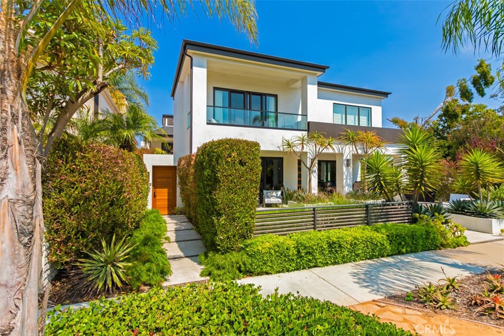 Situated on a rare oversized 55-foot lot just two blocks from the beach, this stunning 3-bed, 3.5-bath ~2,472 sqft rear unit home captures the essence of coastal living in the heart of Corona del Mar Village. Built by Nicholson Companies, the designer home blends timeless charm with modern sophistication. Enjoy seamless indoor-outdoor living with a private front patio and gas fire pit, expansive oversized rooftop deck with panoramic sunset views, and an open-concept interior designed for both comfort and entertaining. Each en suite bedroom offers a private retreat, while the spa-inspired primary suite features premium finishes, soaking tub, and soft contemporary finishes. Additional highlights include wide hallways, large scale rooms, a true open concept, thoughtfully designed staircase, and a rare double-entry car garage. Just steps away from multiple beaches, world-class dining, and boutique shopping, this home offers the ultimate California beach-chic lifestyle.
