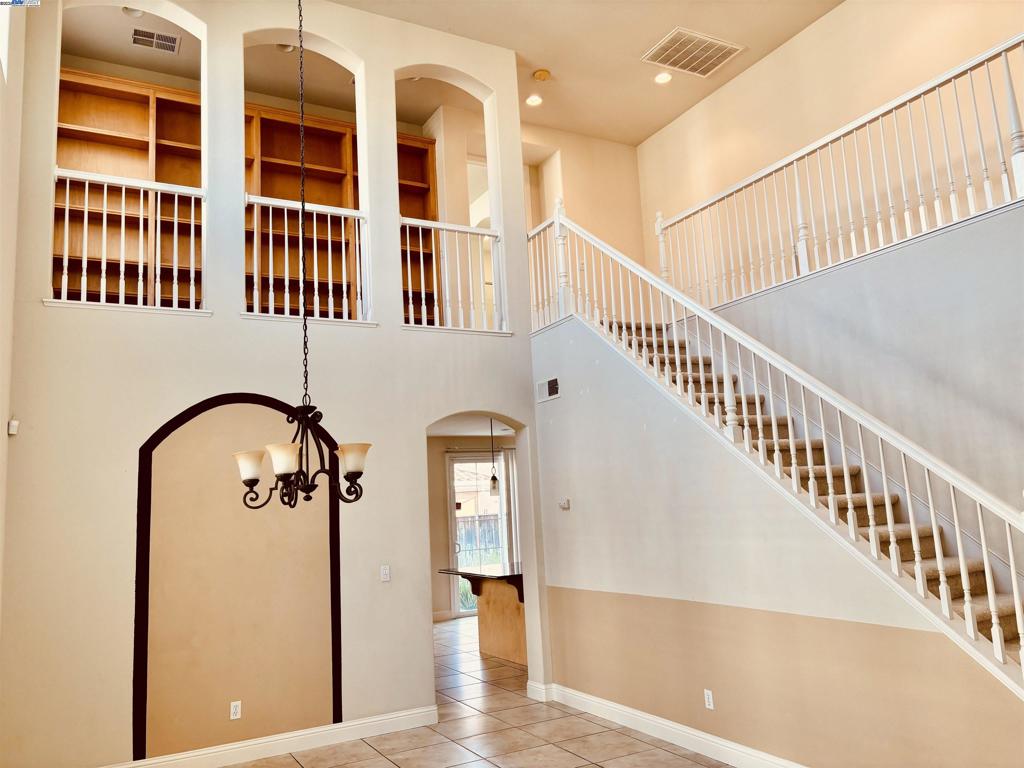 Gorgeous 4 Bedroom, 2.5 Bath with High Entry Ceiling. Tiles flowing from Entry Way to Dining, Kitchen, Family, breakfast Nook, Pantry and into the Laundry Room. Kitchen with Granite Counter Tops, Center island with Double stainless steel sink. Appliances include New 5 Burner Gas Cooktop, Microwave, Oven, Dishwasher and Garbage Disposal. Pantry Space. Separate Laundry Room include Washer/Dryer, sink and Cabinets. Garage Floor with Epoxy. Dual AC and Heating System. This Home is a MUST See !!