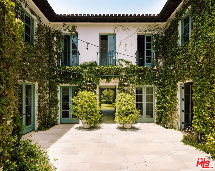 Brand new look!! This stunning California Mediterranean residence, nestled in the sought-after street of the Pacific Palisades' Riviera neighborhood, presents a rare opportunity to own one of the Westside's most exquisite properties. Crafted by acclaimed architect Thomas Proctor, this timeless home boasts meticulous attention to detail in its finishes, windows, arches, wrought iron gates, fireplaces, and more, appealing to the most discerning of buyers. Embracing the allure of Mediterranean-style architecture bathed in sunlight, it seamlessly blends Californian sensibilities with balconies, patios, porticos, and a captivating loggia that offers sweeping panoramic vistas across the canyon to the mountains. The outdoor living area, featuring a limestone fireplace and heated floors, becomes a haven for enjoying breathtaking sunsets. A splendid vaulted gallery leads to a grand living room on one side and an elegant dining room on the other. A walnut-paneled circular office/library stands as a private retreat, connected to the entry courtyard. At the heart of the home lies a den/family room with a limestone fireplace, complemented by arched doors opening to the loggia, yard, or kitchen. The breakfast area, adorned with a raised fireplace, and a spacious kitchen, equipped with a central island, cater to culinary needs with grace. Upstairs, the primary suite, accompanied by two walk-in closets and a spa-like bath, shares in the serene, breathtaking views. Additionally, three generously sized ensuite bedrooms and a gym occupy the upper level, while an extra bedroom resides downstairs. The residence boasts four zones of HVAC, a three-car garage, an outdoor shower, and a wine cellar, ensuring both luxury and practicality.