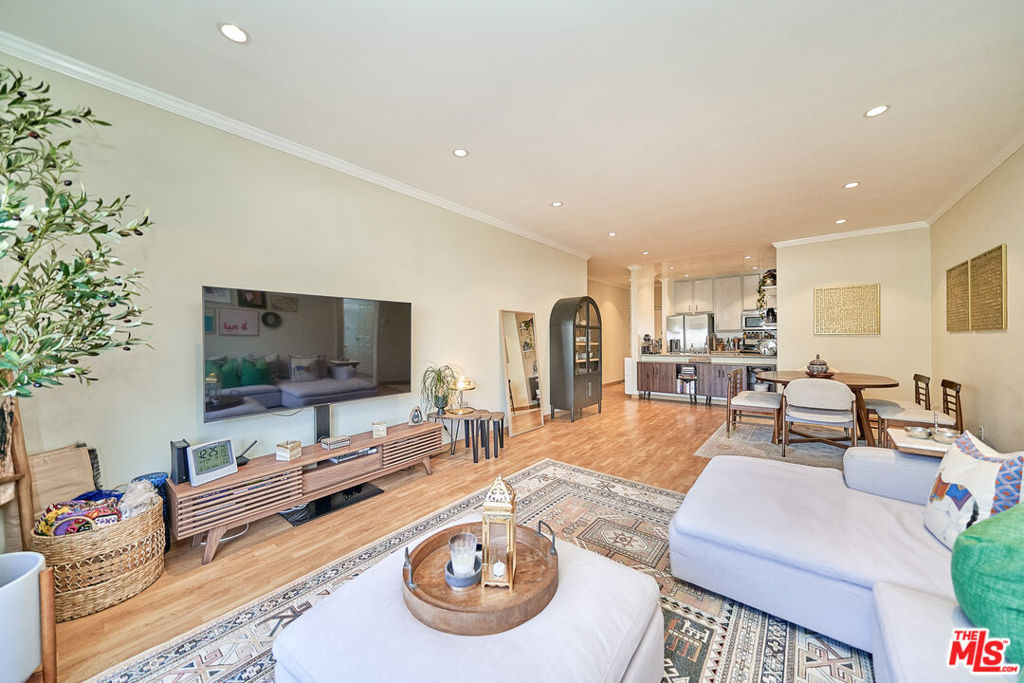 Welcome to The Westmoreland Chateau, Your Gateway to Koreatown Living! This bright and spacious 2-bedroom, 2-bathroom corner unit is the perfect opportunity for first-time homebuyers or savvy investors. Equipped with a brand-NEW, high-efficiency SEER 17.8 air conditioner for year-round comfort and energy savings! With a fantastic price point and low HOA fees, this move-in ready condo offers incredible value in one of LA's most vibrant neighborhoods. Step inside to find an open floor plan that blends the kitchen, dining, and living areas, enhanced by a bar-height counter that adds a sense of space and functionality. The kitchen is thoughtfully RENOVATED with NEW REFRIGERATOR, ample cabinet storage and generous counter space, ideal for cooking and entertaining. Enjoy morning light and city views from the large front-facing balcony, while straight hardwood-style floors throughout add a clean and contemporary touch. The primary suite offers privacy at the end of the hall, complete with a walk-in closet and spacious layout. The guest bedroom is bright and inviting located next to a well appointed full bathroom. Additional highlights include: Tandem parking, rare private storage room (~4x5 sq ft), secured gated building with Butterfly MX intercom system for smartphone access. Close to parks, supermarkets, and top-rated Koreatown dining, easy access to freeways and the subway via Vermont Blvd. Located in the heart of Koreatown, this unit offers unmatched walkability and access to everything the city has to offer. Don't miss out on this hidden gem schedule your tour today before it's gone!
