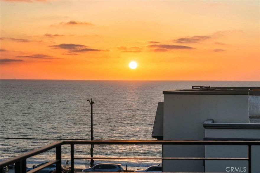 Situated just a few steps from the beach and the heart of Riviera Village, this contemporary coastal home offers a rare blend of modern design and everyday livability in one of the South Bay’s most vibrant neighborhoods. The cafés, restaurants, and boutique shops of the Village are moments away, yet the home feels private and serene. Spanning approximately 3,200 square feet, it features four bedrooms, four and a half bathrooms, and a private three-stop elevator connecting all levels.



Wide-plank French white oak floors flow throughout, adding warmth to the home’s clean architectural lines. The second level includes three bedroom suites, each with its own bath. The primary suite features a private balcony with ocean views, a custom walk-in closet, and a spa-inspired bathroom with dual sinks, a soaking tub, and a large shower.



On the main level, the kitchen, dining, and living areas come together in an open layout designed for comfortable, effortless living. The kitchen features Calacatta marble countertops, a floating center island, Sub-Zero and Wolf appliances, and a walk-in pantry. The living area opens to a wraparound deck where you can enjoy the ocean air and views that stretch toward the horizon.



From the main living space, stairs lead to a rooftop deck with sweeping, unobstructed views of the ocean and city lights—an ideal place to take in the sunset. On the lower level, a spacious media room is fitted with a high-end golf simulator, creating a versatile space for entertainment and leisure.



Blending contemporary design, ocean views, and an exceptional location, this home captures the essence of refined coastal living in South Redondo Beach.
