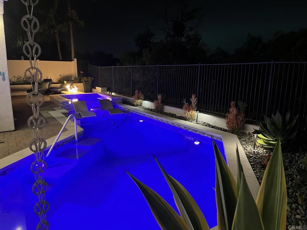 Located in the prestigious Summit community of Ocean Hills, this beautifully remodeled home blends luxury, functionality, and stunning valley views. The backyard is an entertainer’s dream—featuring a newer pebble tech pool and spa, swim-up bar, built-in BBQ, multiple fire pits, and expansive outdoor spaces to relax or host guests. A well-appointed ADU with its own full kitchen, bedroom, and bathroom adds flexibility for multigenerational living, guests, or rental income. The designer kitchen boasts quartz countertops, white and gray shaker cabinets, a full glass tile backsplash, and premium stainless steel appliances from KitchenAid and LG, including a wine fridge and farmhouse sink. The spacious family room includes a romantic fireplace and French doors that open directly to the backyard oasis.
