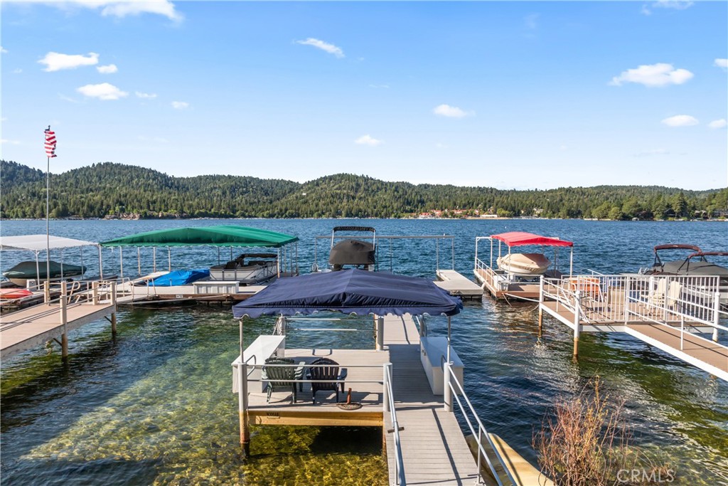Own half of a double dock perfectly positioned in North Bay, just a short stroll from Tavern Bay. Dazzling vistas of Lake Arrowhead, the mountains and forests are the backdrop to lazy afternoons of fishing or exciting days boating and waterskiing. You’ll even have the perfect view for the lake’s spectacular fireworks shows! Parking is easy, conveniently located near the UCLA conference center. The adjacent beach club offers a beach, picnic area and restrooms for added convenience. A brand new access staircase from the trail to the dock has been approved by Arrowhead Lake Association. The pontoon boat is not included but a new pontoon lift with solar panel comes with the dock. Get ready for summer fun in the sun!