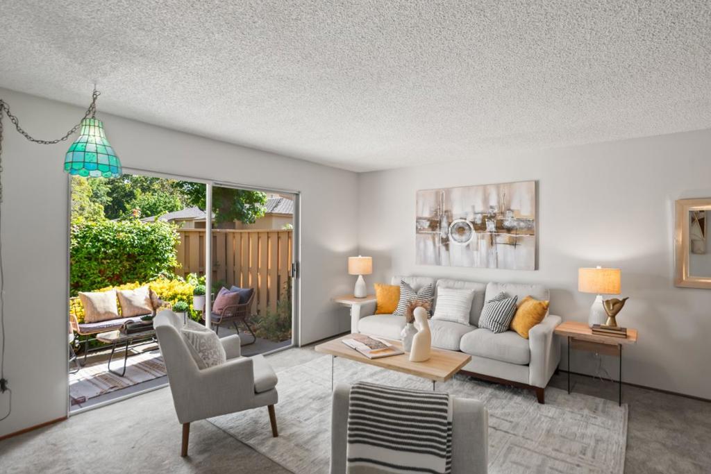 Peaceful, well-maintained home with popular mid-century modern aesthetic in highly sought-after location. Cook delicious meals in the open kitchen that includes convenient peninsula with pass-through to the dining area, making hosting a breeze. The east-facing bedrooms are very private thanks to a fence just outside. Plus, they offer maximal storage with a rare walk-in closet in the primary bedroom and dual closets in the second bedroom. Additional must-have features include in-unit washer/dryer, central A/C for climate comfort, two sun tunnels that fill the home with natural light, and convenient carport with storage. Plus, western sun is blocked by neighboring unit for added comfort. The private yard with southern exposure offers a peaceful, secluded retreat with low-maintenance design that has a sprinkler system for easy care. Outside, the unit is set far back within the complex and situated behind a tranquil lawn area. Meticulously maintained community offers lush greenbelts, clubhouse with large heated pool and lawn, and plenty of parking. Students have access to top Cupertino schools in Stocklmeir Elementary, Cupertino Middle, and Fremont High (buyer to verify)!