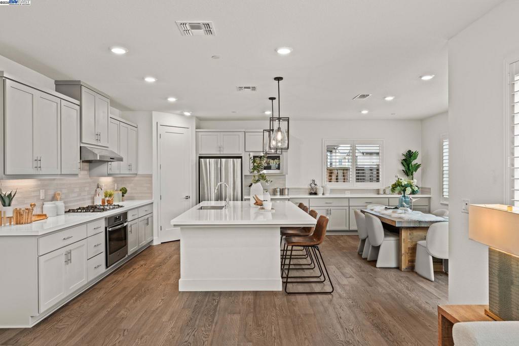 The ideal layout everyone’s been waiting for - modern, open, and effortlessly functional! This stunning 2018 home in the sought-after The Preserve community features soaring two-story ceilings at the entry, a full bedroom and bath on the main level, and a versatile loft upstairs. The open-concept Great Room, Dining, and Kitchen flow beautifully for everyday living and entertaining. The thoughtfully designed outdoor space lives like a true extension of the home: a built-in gas cooktop, fireplace, retractable awning, and stylish seating create a charming retreat for relaxing or entertaining. The chef’s kitchen shines with quartz counters, a large island, walk-in pantry, and ample storage. Upstairs, the luxurious owner’s suite boasts hillside views, a spa-style bath, and a large walk-in closet. A guest bedroom enjoys a private balcony and its own walk-in closet. Additional upgrades include hardwood floors, plantation shutters, owned solar, smart home and electric car charger. Serviced by EBMUD, offering some of the best water quality in San Ramon. Enjoy resort-style amenities including a clubhouse, pool, bocce ball, BBQ area, scenic walking and biking trails, and a 12.7-acre city park. Easy access to I-680, shops, restaurants, and top-rated San Ramon schools! www.318Paradiso.com