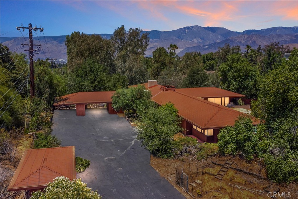 Nestled on 2.4 acres of lush, tree-lined privacy, this 1962 built home by Gordon Donald (inspired by Frank Lloyd Wright), blends timeless architecture with serene natural surroundings. Offering beautiful views, this 4-bedroom, 3 bath residence is a canvas of potential, ready for your vision to restore its former glory. The home features custom built-in cabinetry throughout and distinctive accents, including unique lighting fixtures that highlight its architectural charm. The inviting pool and deck, accessible from the foyer, primary bedroom and hall bathroom, create an ideal space for relaxation and entertaining. While the home boasts incredible bones, it awaits revitalization with opportunities to replace flooring, drapes, and other elements to recapture its original splendor. Embrace the chance to reimagine this architectural gem into your dream retreat.