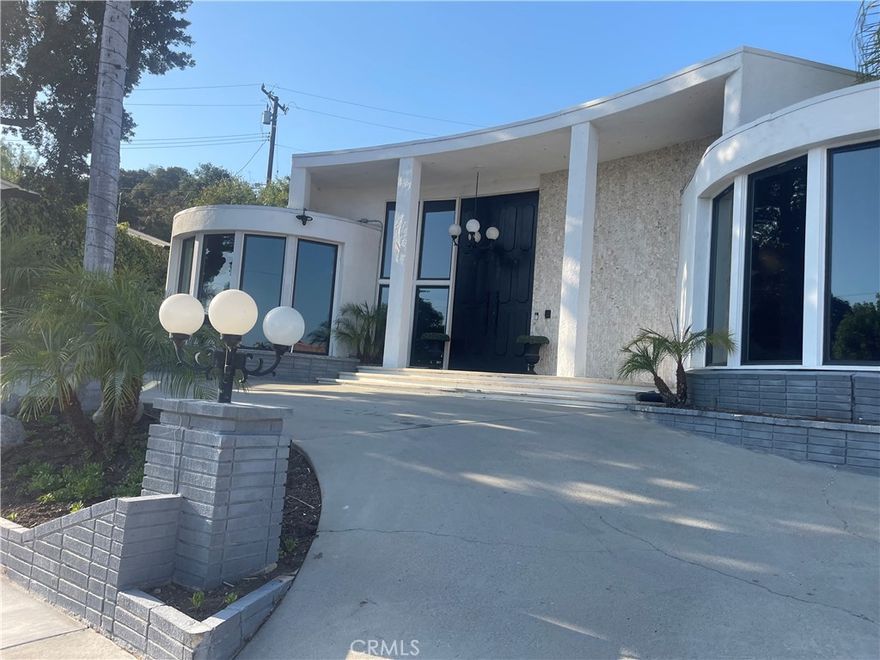 Stunning 5 bedroom, 5 bath hillside retreat in Montebello. This beautiful home boasts large, tinted windows framing breathtaking views. Character-filled interior, spacious pool perfect for relaxation. The master suite features a large bathroom, dual sinks and expansive walk-in custom closet. Additional highlights include a spacious laundry room with ample storage and folding area. Entertain in style with a large formal dining area, wet bar, and elegant formal living room. Dual driveways provide convenient access: one to the main entrance and another to the garage with direct access to the backyard. Strategically located near the freeway, Montebello Mall, hiking trails, and Whittier Narrows Park for effortless convenience, shopping, and outdoor recreation. Schedule a private showing to experience this luxurious property. The house is almost done being remolded the flooring and kitchen are last to be finished.  This home makes a statement and is beautifully breathtaking.