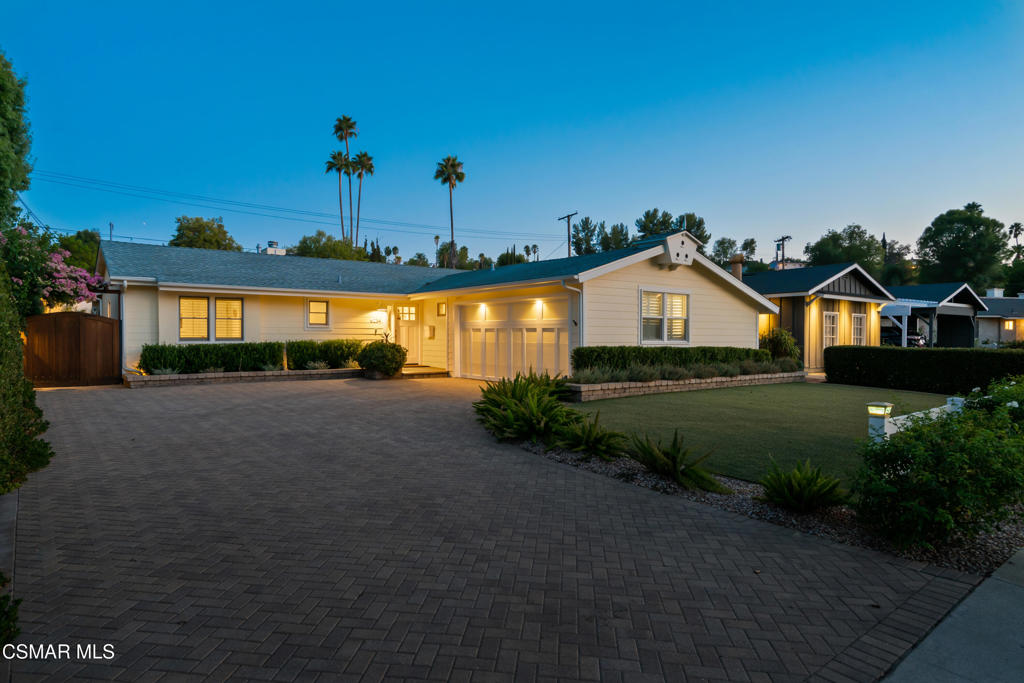 Carefree Living in the Heart of Woodland Hills!This celebrity-owned single-story retreat has been recently elevated with designer fixtures, a fresh neutral palette, and thoughtful upgrades at every turn. Blending timeless sophistication with comfort and ease, this home is the definition of low-maintenance luxury--where every detail has already been considered and every upgrade has already been done for you.The elegant living room sets the tone with a gas fireplace, custom wet bar with cabinetry, and French doors that frame views of the private backyard. Throughout the home, walnut wood floors and marble tile create a seamless flow, complemented by Restoration Hardware cabinet pulls, high-end wallpaper, and designer lighting from Visual Comfort and Design Within Reach. The versatile third bedroom/office is fully soundproofed with built-in walnut cabinetry and its own split system A/C, making it ideal for creative work or private study.The chef's kitchen is both stylish and functional, with freshly painted cabinetry, granite countertops, Viking, Bosch, and KitchenAid appliances, and a walk-in pantry with wine storage. The primary suite is a sanctuary all its own, featuring cove lighting, dual closets, a custom TV cabinet, and a spa-inspired bathroom with heated tile floors, a steam shower, and a multi-jet shower system with body sprayers. The guest bath also includes heated tile flooring, adding comfort for family and guests alike.Step outside to your own private resort. A large saltwater pool with autofill, oversized spa with spillover, and app-controlled features set the stage for year-round enjoyment. The outdoor kitchen boasts a built-in grill with vent hood and Dekton counters, while travertine pavers, ceiling fans, a Bromic heater, and a misting system keep outdoor living effortless in every season. Gas fireplaces, a firepit, extensive landscape lighting, and mature hedges create a tranquil, private escape perfect for gatherings large or small.Additional highlights include owned solar panels, turf lawn, Rachio-controlled irrigation, Nest cameras, and a full security system. The garage has been upgraded with its own split system A/C, built-ins, a car vacuum, and abundant storage. Recent enhancements include a new front door, updated pendants and sconces, painted cabinetry, and more.Tucked away on a peaceful tree lined street, near top-rated schools, shopping, and dining, this is a rare Woodland Hills opportunity--a home where every detail has been considered, every upgrade has been done, and everyday living feels like a vacation.