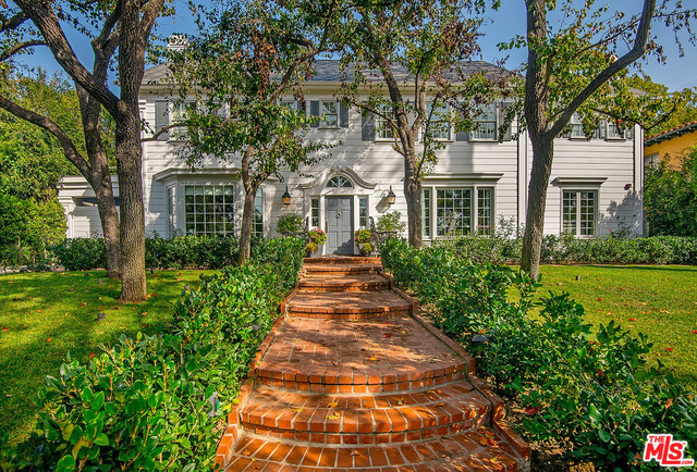 Located on one of the most charming tree-lined streets in the Beverly Hills Flats, this gorgeous gated East Coast Traditional has been remodeled and rebuilt w/exquisite detail & quality. On an apx. half-acre flat lot, this property offers an apx. 7,000 sf main residence, apx. 2,000 sf brand new guest house, & park-like grounds including pool, spa, lawns, intricate landscaping, an abundance of outdoor entertaining spaces, built-in bar & BBQ, & 3-car garage. Main home features 5 bds & 6 bths, formal living rm, formal dining rm, den/office, chef's kitchen, breakfast rm, family rm, & screening rm. Features incl. gorgeous woodwork, built-ins, hwd floors, custom lighting & window treatments, security cameras, & smart home system. Master suite is much like its own residence w/private foyer, sitting rms, vaulted ceiling, fp, private balcony, dual spa-like bths & walk-in closets. Guest house features 1 bdrm, 3 bths, living rm, open kitchen, & huge upstairs space now being used as gym.