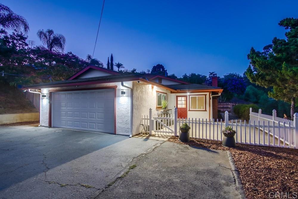 Experience the perfect blend of modern comfort and relaxed charm in this beautifully updated home, ideally located just 20 minutes from the beach. Set on an elevated lot, it captures refreshing ocean breezes and features a welcoming front patio—an ideal spot to enjoy your morning coffee or unwind in the evening with sparkling city light views. The expansive, private backyard—spanning over half an acre—offers a peaceful retreat, perfect for entertaining, outdoor dining, or simply relaxing in nature. The low-maintenance, drought-tolerant landscaping is enhanced by lush turf that stays green year-round, combining beauty with practicality. Step inside to find a remodeled kitchen and bathrooms, thoughtfully finished with modern fixtures, stylish design elements, and a clean, contemporary aesthetic. Rich hardwood floors flow throughout the living areas, creating warmth and cohesion. The open layout is perfect for both daily living and entertaining. The primary bedroom includes a private en suite bath for added comfort. Additional upgrades include brand-new windows installed in 2017, a new roof added in 2019, and all new attic insulation in 2024—making this home truly move-in ready. Offering the serenity of a hillside retreat while keeping you close to beaches, dining, and shopping, this home embodies the best of Southern California living with timeless appeal and modern upgrades.