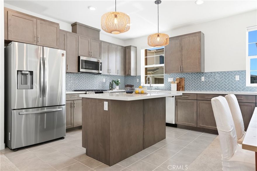Welcome to 221 Gallop Court, a highly upgraded Paisley Plan 4 in the award-winning community of Rancho Mission Viejo! This one stands out for its thoughtful design, elevated finishes, and ideal location just steps from Ranch Cove Pool, Boulder Pond, and the community Park. From the moment you step inside, you’ll feel the quality. The home features a spacious open layout with extended kitchen cabinetry and counters, full-tile backsplash, quartz countertops throughout, and premium GE Café stainless appliances. The living room is wired for surround sound and features LED recessed lighting, a TV conduit, and added insulation for comfort and soundproofing. Upstairs, the owner’s suite includes double sinks, a full-height tile shower, a custom barn door, and mountain views of Santiago Peak. Every detail has been dialed in: epoxy garage floors, pendant lighting over the kitchen island, under-cabinet LED lights, ceiling fans, and smart dimmers throughout. The home also includes upgraded tile and carpet flooring, a full laundry room and one bedroom with a full bath on the 1st floor. The exterior has been beautifully finished with front and side hardscaping, landscaped patios, and café lights on the upper deck. Added perks include paid Solar with 9 panels, a Nuvia whole-house soft water and reverse-osmosis filtration system, EV car charger outlet, and even a digital smart lock for everyday convenience. Immerse yourself in the exceptional amenities of Rancho Mission Viejo, including the vibrant Ranch Camp, the state-of-the-art Ranch Cove community pool and gym, and countless recreational opportunities that define the unmatched lifestyle of this community. Exclusive to Rancho Mission Viejo residents are all amenities in the Villages of Sendero, Esencia, Rienda, and future Villages. There are community amenities for all from breath-taking resort-style pools and spas, Esencia school K-8, community farms, fitness centers, guest house, putting green, bocce ball courts, tennis and pickle ball courts, playgrounds, coffee shop, fire pits, an arcade and so much more!