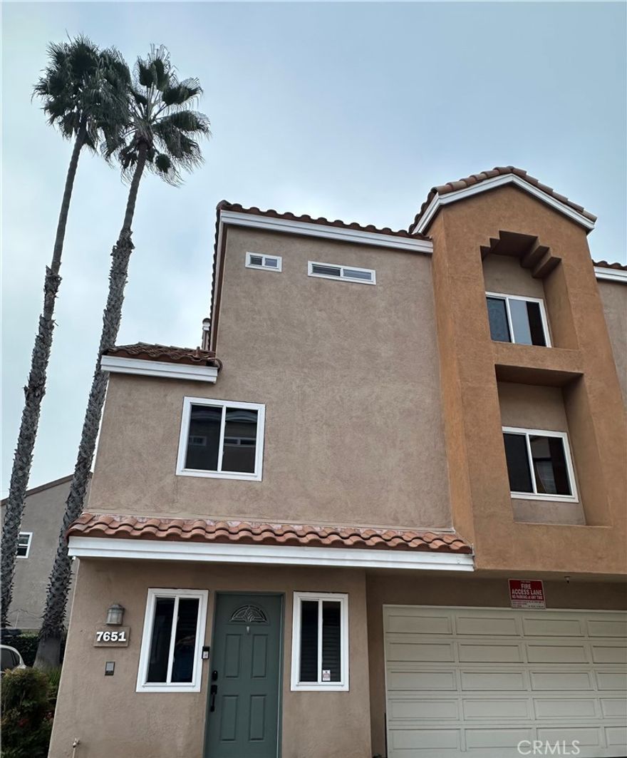 Situated on a quiet cul-de-sac just minutes from the beach, this Huntington Beach townhome offers the perfect balance of coastal convenience and neighborhood charm. With easy access to shopping, dining, schools, and major freeways, the location delivers true surf-city living with everyday ease.
This Mediterranean-style front, end unit features an open floor plan with an updated kitchen showcasing granite countertops, stainless steel appliances, and wood flooring in the kitchen and dining area. Newer dual-pane windows with wood blinds enhance comfort and efficiency, while the living room is anchored by a cozy gas log fireplace.  

Upstairs are two spacious primary suites, each with vaulted ceilings and a full en-suite bath. A conveniently located powder room serves the main living level. One of the home’s highlights is the private rooftop deck, ideal for entertaining, relaxing, or enjoying special events and airshows. Additional outdoor space includes a wood-fenced ground-level patio and garden area.

A large two-car garage offers ample storage and a separate laundry area with gas and electric hookups. A private exterior staircase provides access to all levels, including the rooftop deck. A rare opportunity to enjoy a unique floor plan, multiple outdoor spaces, and a prime Huntington Beach location.