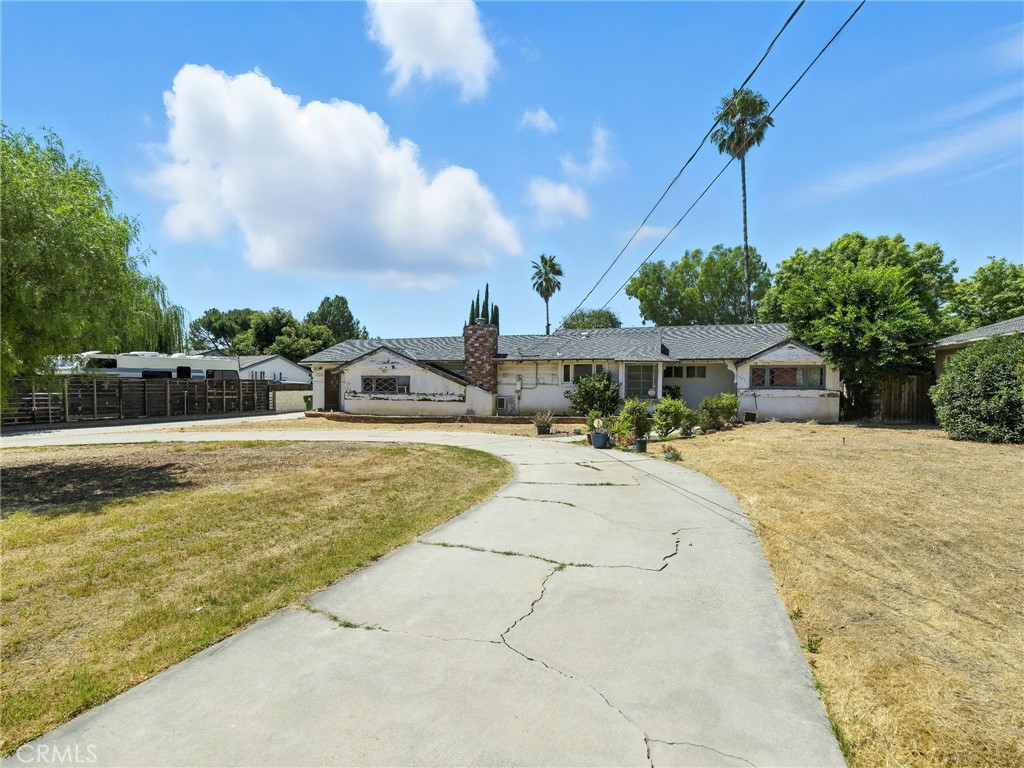 Set on well over one third of an acre in a quiet, low traffic, prime neighborhood, this fixer is brimming with value and opportunity. This home offers 3 bedrooms, 2.5 baths, a spacious living room, dining and breakfast area, and a step down family room with fireplace and wet bar. Beautiful wood-beamed vaulted ceilings run throughout adding warmth and architectural appeal. An approximately 20' by 18' garage conversion adds even more flexibility and is ideal for a studio, home office or an expansion of your choice. The lot features two driveways. A circular driveway to the main home and a front to back straight driveway that's easy for accessing a possible ADU which is ideal for multi-generational living or big rental income. This is the perfect canvas to create your dream home in a quiet and beautiful neighborhood.