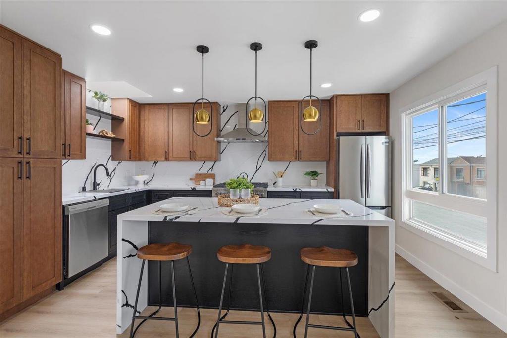 Just blocks from the ocean and Golden Gate Park, this newly remodeled 3-bedroom, 2-bath home offers modern design in San Franciscos desirable Outer Sunset. Steps from the vibrant Taraval and Noriega corridors, the property blends contemporary elegance with coastal neighborhood charm. Inside, an open-concept floor plan is filled with natural light from three skylights. The chefs kitchen is a showpiece, featuring waterfall quartz countertops, luxury cabinetry, designer lighting, and professional-grade appliances. The living area is anchored by a sleek modern electric fireplace with a dramatic tile surround. With its open design, the home offers flexible dining and entertaining optionscreate the layout that suits your lifestyle. Bathrooms feature spa-inspired finishes, including custom tilework, gold fixtures, and curated details. Throughout, recessed lighting, premium flooring, updated electrical, and a new HVAC system ensure both style and comfort. Outdoors, a newly landscaped backyard provides a private retreat designed for relaxation and low maintenance. Whether entertaining friends, gardening, or unwinding, this space offers endless possibilities. Schedule your private showing today and experience this luxury Outer Sunset residence for yourself.