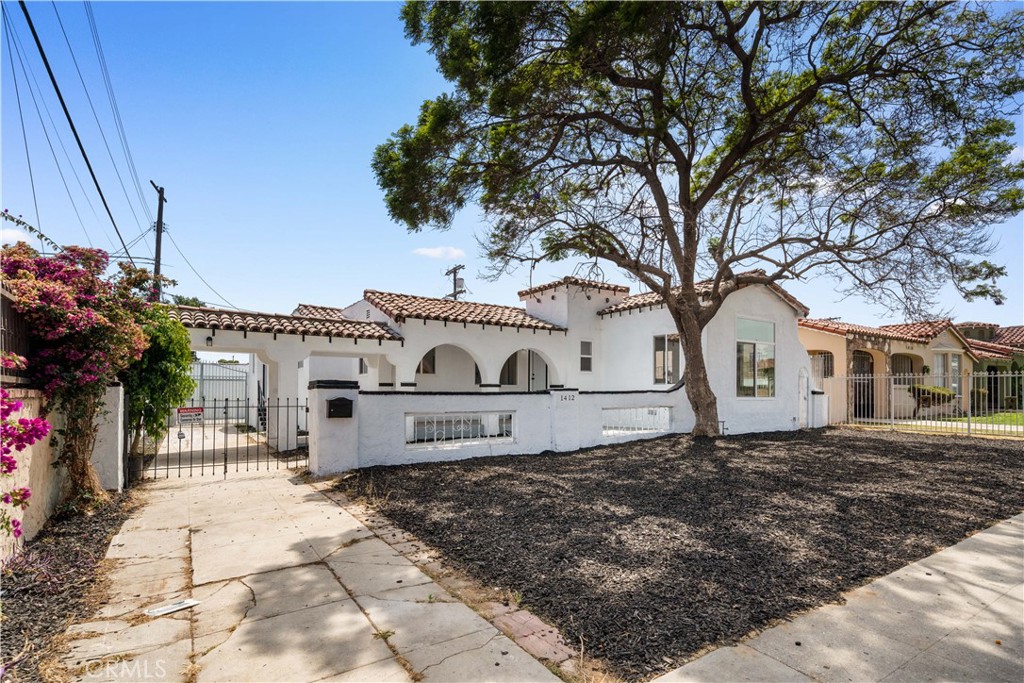 Welcome to 1412 W 93rd, a beautiful Spanish home in the heart of Gramercy Park, Los Angeles. Situated on a spacious lot, this home features 3-bedroom, 3-bath, offering 1,752 SqFt living space. The bright and airy living room flowing effortlessly into the open concept kitchen and dining area. Off the kitchen featuring granite countertops, ample cabinets, and stainless steel appliances. Out of 3-bedroom, two has en suite bath. The garage has been transformed into a versatile recreation space, perfect for a home office or personal gym. This move-in ready home boasts brand-new flooring, new windows, smooth ceilings with recessed lighting, and fresh paint throughout. Located just minutes from new SoFi Stadium, LAX, and major freeways. The home is ideal for those seeking both comfort and convenience in an up and coming LA neighborhood.