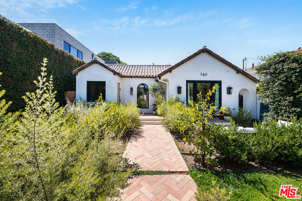 Situated West of Lincoln in the heart of Venice, this exquisitely remodeled single-story residence blends classic Spanish charm with contemporary elegance. Thoughtfully crafted with high-end finishes, the home features wide-plank white oak floors, exposed Douglas fir beams, and soaring vaulted ceilings, all anchored by custom wood doors with premium M Tech hardware.Warm, ambient lighting highlights the artisanal details throughoutfrom hand-finished cabinetry and Calcutta marble countertops to handcrafted Zellige Moroccan tile and unlacquered brass fixtures. The gourmet kitchen boasts a Sub-Zero refrigerator, Bertazzoni 6-burner range, and a stunning Roman plaster range hoodperfectly positioned in an open layout that seamlessly connects the living, dining, and family areas. Sliding glass doors open to the lush backyard, ideal for indoor-outdoor entertaining and al fresco dining. The serene primary suite offers dual built-in wardrobes, double vanities, an oversized shower adorned with Zellige tile, Rohl fixtures, and a French door that opens to a private garden. Three additional bedrooms and two beautifully designed baths are set in separate wings, offering privacy and space. Surrounded by mature landscaping including olive trees, lavender, and rosemary, the property is gated and private with elegant herringbone Sausalito tile pathways, a spacious grassy yard, and a two-car garage with EV charging. This home is a true sanctuary effortlessly sophisticated and ready for your arrival. One year minimum lease period only. Available furnished or unfurnished.