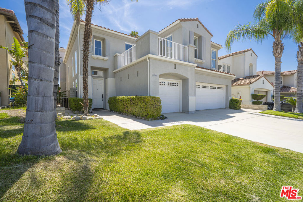 Welcome to this beautifully refreshed Stevenson Ranch home, featuring a sparkling pool and breathtaking views! This spacious and desirable residence offers five generously sized bedrooms, four full bathrooms, and a versatile den perfect as an office, library, or bonus space for today's lifestyle. The popular open floor plan features an expansive kitchen with views of the backyard and pool, flowing seamlessly into the dining and living areas. Soaring ceilings in the living room and den create a sense of openness and grandeur, while large windows fill the home with natural light. A downstairs bedroom with a full bathroom is ideal for guests or multigenerational living. Hardwood floors extend through the main level and into the upstairs primary suite. The primary bedroom includes a private balcony with peaceful views of the backyard and Santa Clarita Valley perfect for morning coffee or evening sunsets. The luxurious en-suite bathroom features dual vanities, a built-in powder table, a jacuzzi tub with a view, and two walk-in closets. Two additional bedrooms share access to a front-facing balcony, and another includes its own full en-suite bathroom great for guests or growing families. All bathrooms have been tastefully updated with quartz countertops and modern fixtures, giving the home a clean, stylish finish. The downstairs den includes built-in shelving and benefits from high ceilings, making it a perfect space for work or study. Additional highlights include an upstairs laundry room, quartz kitchen countertops, plantation shutters, updated lighting, and detailed moldings. A three-car garage is equipped with an EV charger, and PAID OFF solar panels provide added energy efficiency. The backyard is a private oasis with a sparkling pool and spa, lush landscaping, and sweeping views ideal for relaxing or entertaining in style. This home is conveniently located near award-winning schools, fine dining, shopping, entertainment, walkable parks, and freeway access. * PAID OFF SOLAR - seller will pay off the solar at COE*