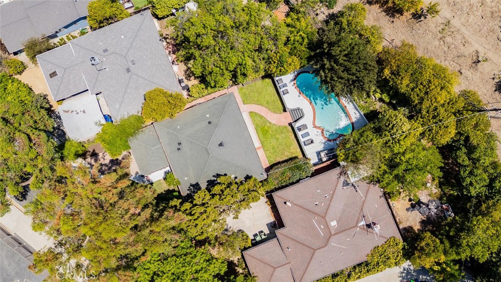 EXQUISITELY REIMAGINED SINGLE-STORY POOL HOME SOUTH OF THE BOULEVARD! Where form meets function, this beautifully remodeled 3-bed, 2-bath, 1,460 square foot home sits on an expansive almost 7,300 square foot lot with a resort-style backyard. The bright, open-concept layout effortlessly connects the kitchen, living, and dining areas to the private entertainer’s yard—complete with a large pool, spa, and grassy play area.. The designer kitchen is a showstopper, boasting quartz countertops, stainless steel appliances, a deep stainless farmhouse sink, and sleek neutral-toned cabinetry with abundant hidden storage. A functional breakfast bar adds convenience and flow for everyday living or hosting guests. The serene primary suite features custom wall-to-wall wardrobes, direct backyard access, and a spa-like en-suite bath with a deep soaking tub and dual sinks. With white oak engineered wood floors, smooth stucco exterior, and high-end modern finishes throughout, this home offers a clean, cohesive, and timeless aesthetic. Experience California living at its finest—sophisticated, stylish, and move-in ready.