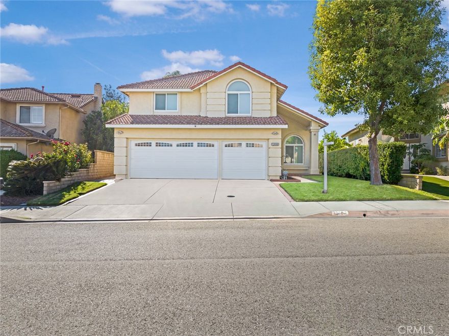 Totally remodeled! Great Location! Beautiful View! This very well maintained property has 5 bedrooms, 3 bathrooms (1 bedroom 1 bathroom downstairs), 3-car garage. Attractive curb appeal, double-door entry. High ceiling in living room and formal dining room. Gourmet kitchen upgraded with white cabinets, quartz counter tops, full mosaic backsplash, and double ovens. Cozy family room with media center, fully upgraded gas fireplace with new mantel, marble tiles, doors, and fire glass. Downstairs guest bedroom with updated full bathroom. The primary suite has large walk-in closet, beautiful rolling hills view. Primary bathroom with quartz counter tops, dual sinks, tile flooring, bathtub and separate shower with frameless glass enclosures. Upstairs has 3 more bedrooms, all with good size. Hallway bathroom also totally remodeled. Other notable features include, laminated flooring in living room, family room and kitchen, carpet in bedrooms, tiles in  bathrooms, custom two-tone paint, newer vinyl double-pane windows and patio door, automatic awnings for formal dining room and primary bedroom windows, custom window shades, recessed lights, new water heater, and downstairs laundry room. Water softener and EV charger installed in garage. The private and peaceful back yard with covered aluminum patio deck, and fruit trees. Enjoy the panoramic rolling hills and valley views. Golden location, on the tranquil hill top, but minutes to city facilities, markets, and parks.  Outstanding Chino Hills schools, Award winning Rolling Ridge Elementary, Canyon Hills Junior High, and Ayala High!