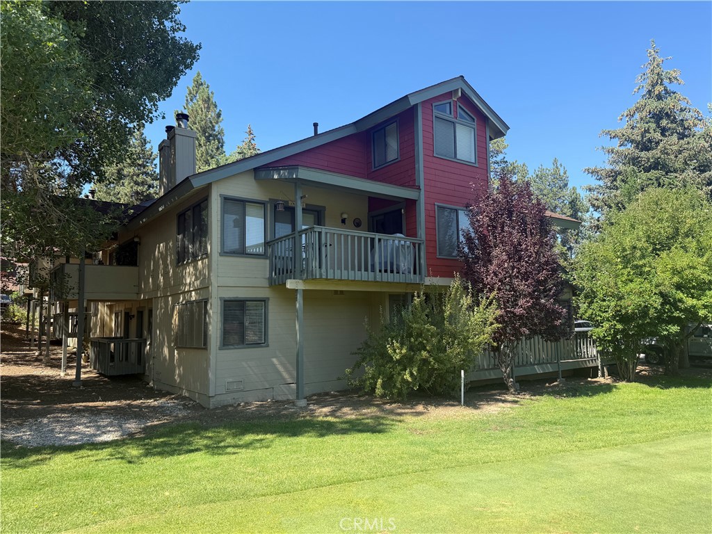 SPACIOUS BEAR MEADOWS CONDO WITH GOLF COURSE AND MOUNTAIN VIEWS - STEPS FROM BEAR MOUNTAIN SKI RESORT! Discover this rare three-bedroom Bear Meadows condo ideally located in Moonridge, just one block from Bear Mountain Ski Resort and next to Hole #2 tee-box of the Bear Mountain Golf Course. Enjoy golf course and mountain views from the comfort of your own home in the largest floor plan in the complex. Featuring two en suite bedrooms plus a loft (serving as a third bedroom) and 2.75 baths, this mountain retreat offers plenty of space for family and guests. The open-concept living room boasts vaulted ceilings, a striking floor-to-ceiling brick fireplace, and direct access to a large covered deck—perfect for bbq'ing or and relaxing year-round. The well-equipped kitchen features tile counters, a breakfast bar, and warm oak cabinetry. A convenient mudroom with gear storage leads to the attached 1-car garage. As a resident of Bear Meadows, you'll enjoy access to a clubhouse, spa, tennis court, and fitness center. And with it's great Summer and Winter location (just minutes to skiing, golfing, hiking, mountain biking, or visiting the Moonridge Zoo), this condo offers the ultimate four-season Big Bear lifestyle. HOA-maintained grounds ensure a low-maintenance mountain home—perfect for a vacation getaway or full-time living. Don’t miss this opportunity to own a prime Big Bear Moonridge condo with unbeatable location, amenities, and views