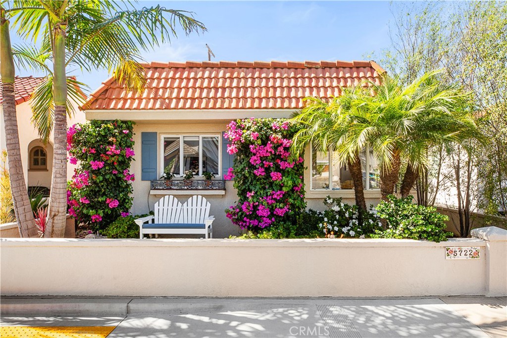 Located in the heart of Naples Island, this pristine 2 bed, 2 bath beach house offers the perfect blend of classic character and modern comfort. Originally built in 1949 and thoughtfully remodeled throughout, the home showcases mid-century design elements, including beamed and vaulted ceilings in the living room and a dramatic stacked-stone fireplace. A private courtyard entry opens to a beautiful outdoor entertaining space, seamlessly connected to the light-filled interior through French doors and a wall of windows. The updated kitchen features stainless steel appliances, custom backsplash, quartz countertops, and a charming built-in banquette dining nook. Both bathrooms boast custom tiled showers, and the two spacious bedrooms include a serene primary suite with attached bath. Move-in ready and just steps from the canals, shops, and dining—this is the ideal coastal retreat!
