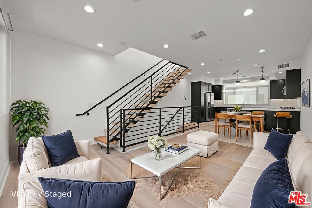 ** PET FRIENDLY ** WASHER/DRYER ** CENTRAL A/C ** PRIVATE GARAGE ** LARGE PRIVATE ROOFTOP DECK ** MODERN LIVING ** Welcome to 11304 Victory Blvd, a beautifully designed and modern 3-bedroom, 3-bathroom single-family home offering 1,624 sq ft of thoughtfully crafted living space in the heart of North Hollywood. Perfectly blending style, comfort, and convenience, this residence is ideal for those seeking a vibrant lifestyle with easy access to the best of the San Fernando Valley. Step inside to an inviting open-concept main level, where natural light pours in through dual-pane windows, illuminating the spacious living room and dining area. The sleek, modern kitchen is a true showpiece, featuring stainless steel appliances, ample cabinetry, and contemporary finishes, perfect for both everyday living and entertaining. From here, enjoy seamless access to a private balcony, extending your living space outdoors for morning coffee or evening relaxation. Upstairs, the expansive primary suite feels like a private retreat, complete with a luxurious en-suite bathroom featuring dual sinks, a walk-in closet, and a large private balcony to enjoy fresh air and city views. The lower level offers flexibility with a junior suite that includes its own en-suite bath, along with a third spacious bedroom and a nearby full bathroom ideal for family, guests, or a home office setup. Additional highlights include a private front yard, central HVAC for year-round comfort, an in-unit washer and dryer, recessed lighting, and a versatile bonus room off the attached 2-car tandem garage that can be used as a home gym, office, or extra storage. Located in a prime North Hollywood neighborhood, this home places you just minutes from the exciting new NOHO West development, the lively Arts District, Burbank Airport, and major freeways, making commuting and exploring Los Angeles a breeze. With trendy dining, shopping, and entertainment at your fingertips, this move-in-ready home offers the perfect balance of modern luxury and everyday convenience. Square footage may include garage - tenant pays utilities.