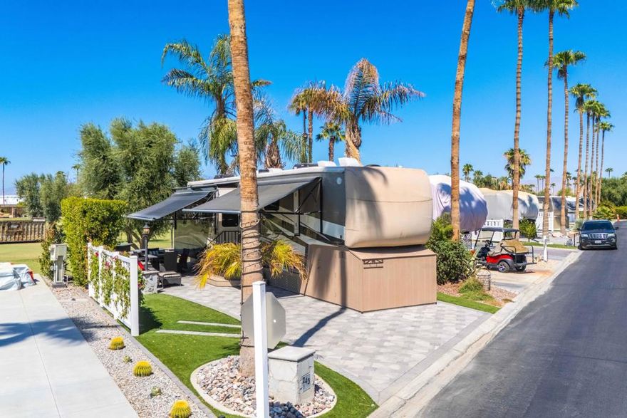 This beautiful golf course lot offers privacy and stunning views in the heart of Outdoor Resorts Palm Springs. Expanded with pavers, the patio side is bordered by fencing and mature hedges, creating a perfect, private space for outdoor relaxation. Enjoy panoramic golf course and mountain views from this prime location. The RV is a pristine 2019 DRV Mobile Suites Santa Fe, offering luxurious living in immaculate condition. Whether you're relaxing on the private patio or enjoying the resort's many amenities, this lot/RV package is move-in ready and ideal for your winter retreat. Ideally situated, this lot is just a short distance from the La Palma Clubhouse, tennis courts, fitness center, pool, and spa, ensuring that top-tier amenities are always within reach. Outdoor Resorts Palm Springs is a Five Star RV Resort Community combining luxury with affordability. It is a guard gated resort that sits on 137 beautifully landscaped acres with 27 holes of executive golf, 10 tennis courts, 13 pickleball courts, 8 swimming pools, a fully equipped fitness center. beauty salon/barber shop. full-service restaurant. convenience store. 2 club houses, activities, special events and so much more