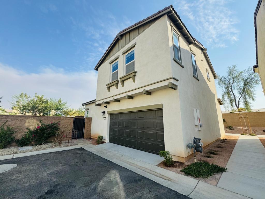 Available for long-term lease. Brand New Home in University Park with solar for low utility bills. This beautiful detached home sits on a corner lot for your privacy! Bright and modern throughout, this home features an open-concept layout with a crisp white kitchen, stainless steel appliances, and a large center island--ideal for entertaining. The main level includes a versatile bedroom and full bathroom, perfect for guests, a home office, or gym. Upstairs, the primary suite offers a spa-inspired bathroom with dual vanities and a walk-in closet. Two additional bedrooms share a full bath. Additional features include: Scenic mountain views, abundant natural light, direct-entry two-car garage, dedicated laundry room, solar panels, low-maintenance yard with paver patio and designer lighting. Resort-style community amenities include a pool, spa, clubhouse, dog park, and green spaces. Prime location near shopping, dining, Acrisure Arena, and the upcoming Palm Desert UC and Cal State campuses.