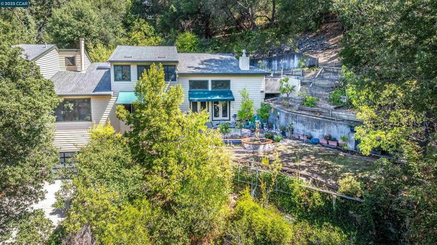 Stunning contemporary 4-bedroom, 3-bathroom home in the coveted Orinda Country Club, offering 4,072 sq. ft. of luxurious living space. This updated estate features a spacious, remodeled kitchen that opens to the family room, with vaulted ceilings and a custom fireplace, creating the perfect space for both entertaining and everyday living. The open floorplan, high ceilings, and large rooms allow for a bright, airy atmosphere throughout.  Bonus 900 sq. ft. Sunroom is ideal for entertaining with granite walls, retractable sunshade, heat & air conditioning - an ideal bonus space! Step outside to a private oasis with a serene Koi pond, fountain, and a spacious deck ideal for gatherings. A beautifully designed sunroom with granite and marble accents provides a peaceful retreat. The primary suite includes a recently remodeled bath with European cabinets and designer granite finishes. The property is filled with orchards and fruit trees, offering privacy and beauty. Located just steps from the Orinda Country Club and top-rated Orinda schools, this home blends peaceful seclusion with convenience. Don’t miss out on this exceptional estate in one of the Bay Area’s most desirable neighborhoods. Views:  Ridge