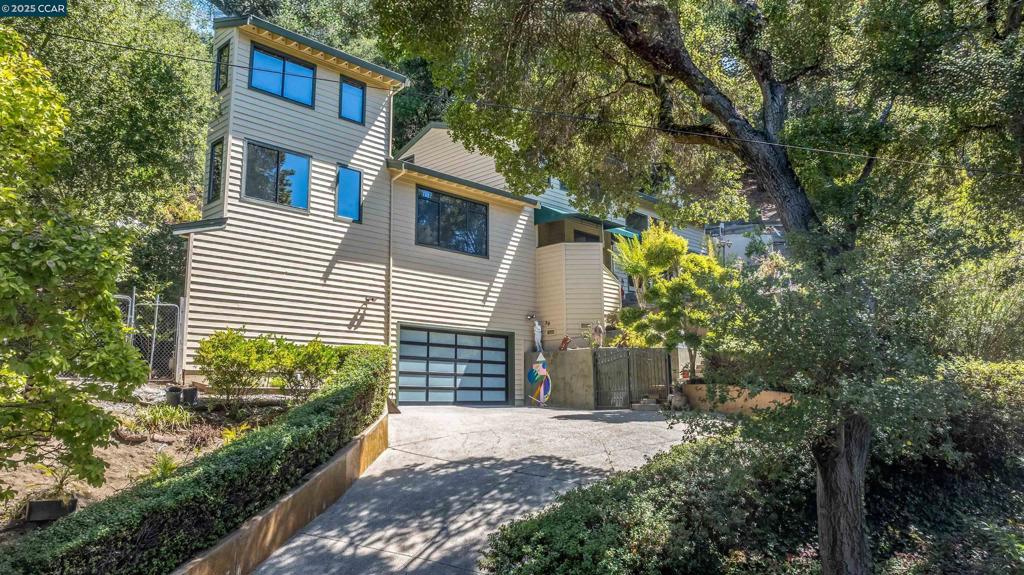 Stunning contemporary 4-bedroom, 3-bathroom home in the coveted Orinda Country Club, offering 4,072 sq. ft. of luxurious living space. This updated estate features a spacious, remodeled kitchen that opens to the family room, with vaulted ceilings and a custom fireplace, creating the perfect space for both entertaining and everyday living. The open floorplan, high ceilings, and large rooms allow for a bright, airy atmosphere throughout. Bonus 900 sq. ft. Sunroom is ideal for entertaining with granite walls, retractable sunshade, heat & air conditioning - an ideal bonus space! Step outside to a private oasis with a serene Koi pond, fountain, and a spacious deck ideal for gatherings. A beautifully designed sunroom with granite and marble accents provides a peaceful retreat. The primary suite includes a recently remodeled bath with European cabinets and designer granite finishes. The property is filled with orchards and fruit trees, offering privacy and beauty. Located just steps from the Orinda Country Club and top-rated Orinda schools, this home blends peaceful seclusion with convenience. Don’t miss out on this exceptional estate in one of the Bay Area’s most desirable neighborhoods. Views: Ridge