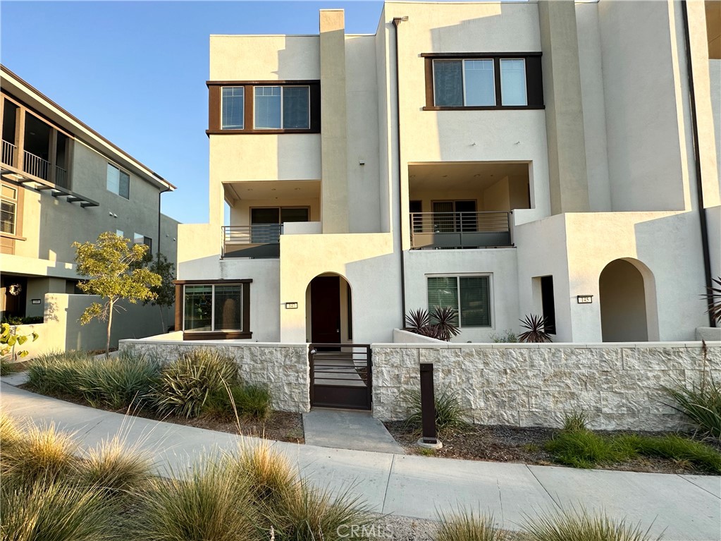 Welcome to this stunning corner unit perfectly situated across from a beautiful park in the highly sought-after Cadence Park community within Great Park, Irvine. This 3-bedroom, 3.5-bathroom townhouse offers 1,933 sq. ft. of open-concept living with a highly desirable main-level bedroom and full bath – ideal for guests or multigenerational living. The first floor boasts an oversized bedroom with an en-suite bath and serene park views — even larger than the primary suite. The chef’s kitchen features a spacious island, quartz countertops, stainless steel appliances, and upgraded cabinetry, seamlessly flowing into the bright and airy great room with expansive windows and recessed lighting. Upstairs, you'll find a luxurious primary suite complete with a walk-in closet and spa-inspired bathroom, plus an additional generously sized bedroom with its own full en-suite bath. A convenient upstairs laundry room adds everyday practicality. Enjoy your private outdoor space, perfect for relaxing or entertaining, along with a 2-car attached garage. As a resident, you’ll have access to resort-style amenities including multiple pools, parks, sports courts, scenic trails, and community events — all in one of Irvine’s most vibrant master-planned neighborhoods.