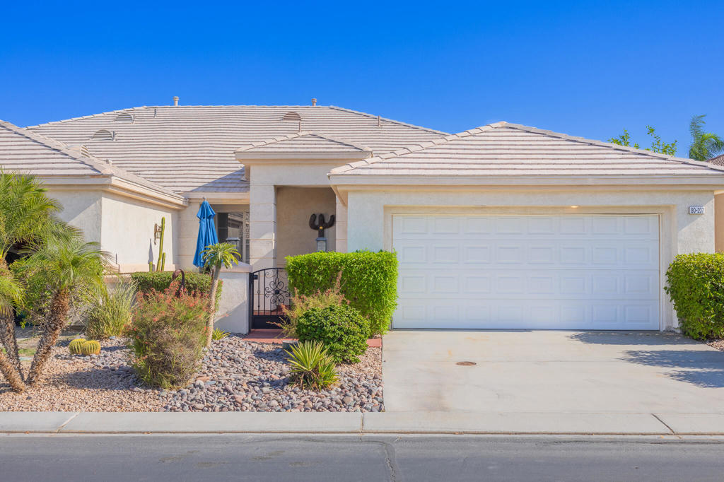Experience the ultimate desert lifestyle in this beautifully furnished home, located within the sought-after 55+ guard-gated community of Heritage Palms Country Club.This well-maintained 2-bedroom, 2-bathroom residence has a charming gated front courtyard and offers a spacious and versatile layout, featuring tile flooring and LVP throughout the home, a generous living room, and a formal dining space perfect for entertaining.The kitchen opens to a cozy family room complete with a gas fireplace, casual dining nook, and bar seating, ideal for everyday living. Step outside to the private, enclosed backyard and enjoy serene mountain views in a peaceful setting.The expansive primary suite features dual vanities, a walk-in shower, and two separate walk-in closets for ample storage. A roomy laundry area provides extra cabinetry and leads to the attached 2-car garage with epoxy floors and additional built-in storage.Residents of Heritage Palms enjoy access to world-class amenities, including a championship 18-hole golf course, resort-style clubhouse, indoor and outdoor pools, pickleball and tennis courts, fitness center, library, restaurant, lounge, and a full calendar of social activities. HOA dues include internet and cable TV for added convenience.