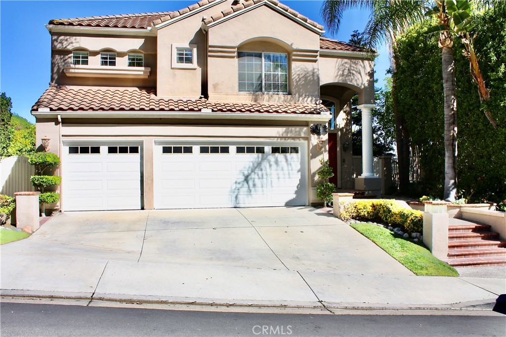 Beautiful four bedroom, four bath Paloma Pool home in Pacific Hills with a view. Three car attached garage w/direct access. Gourmet kitchen with granite countertops and tumbled travertine backsplash. Wet bar with hammered copper sink. Hardwood flooring in living room, family room and kitchen. Downstairs bedroom with private full bath. Master suite with organized walking closet. Newer carpet in all upstairs bedrooms, Master bath with newer vinyl plank flooring. Entire house has recently been re-piped. Newer air conditioning and heating for the first floor living area. Three fireplaces in living room, family room and master suite. Ceiling fans, plantation shutters. Entertaining backyard with sparkling pool, spa and BBQ center. Lake Mission Viejo privileges. Close to FWY 5, schools, shopping, parks and restaurants.