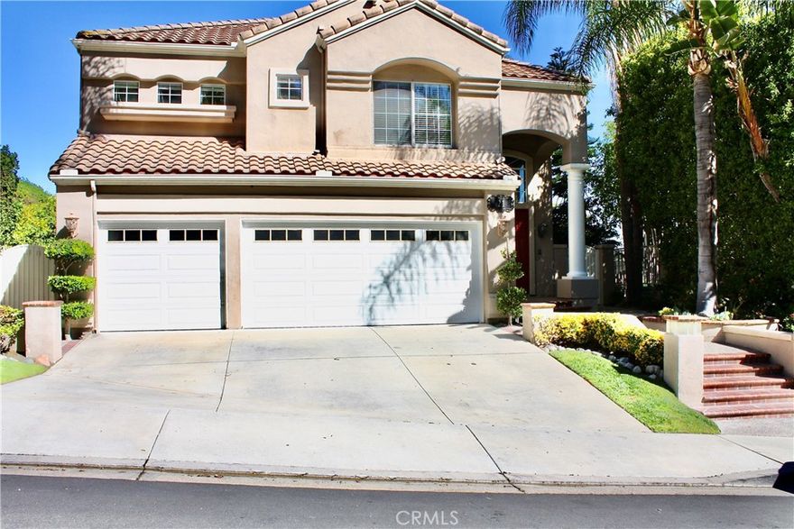 Beautiful four bedroom, four bath Paloma Pool home in Pacific Hills with a view. Three car attached garage w/direct access. Gourmet kitchen with granite countertops and tumbled travertine backsplash. Wet bar with hammered copper sink. Hardwood flooring in living room, family room and kitchen. Downstairs bedroom with private full bath. Master suite with organized walking closet. Newer carpet in all upstairs bedrooms, Master bath with newer vinyl plank flooring.  Entire house has recently been re-piped. Newer air conditioning and heating for the first floor living area. Three fireplaces in living room, family room and master suite. Ceiling fans, plantation shutters. Entertaining backyard with sparkling pool, spa and BBQ center. Lake Mission Viejo privileges. Close to FWY 5, schools, shopping, parks and restaurants.