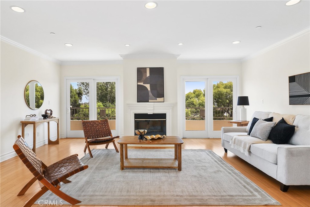Proudly introducing this spacious 3-bedroom, 2.5-bath corner unit spanning 1,740 sq. ft., perfectly positioned in a highly sought-after Westwood area. With a desirable southeast orientation, this home captures abundant natural light and offers panoramic depth views from its wraparound balcony. The open-concept living and dining area showcases elegant bamboo flooring, recessed lighting, and a decorative fireplace, all seamlessly connected to the balcony through three sliding glass doors—ideal for both relaxing and entertaining. The updated kitchen features quartz countertops, crisp white cabinetry, stainless steel appliances, a wine fridge, and a farmhouse sink. The primary suite boasts plush carpet, a walk-in closet, and sweeping city views. Its en-suite bath offers a spa-like retreat with a freestanding soaking tub and separate shower. Two additional bedrooms also feature fresh carpet and share a well-appointed bath. In-unit laundry is conveniently located in the hallway. Residents enjoy a well-maintained complex with an elevator, fitness center, serene courtyard, two assigned parking spaces with EV charger capability, and guest parking. All of this is set in an unbeatable location moments from UCLA, Westfield Century City, Westwood Village, Beverly Hills, and within the coveted Westwood Charter School district.