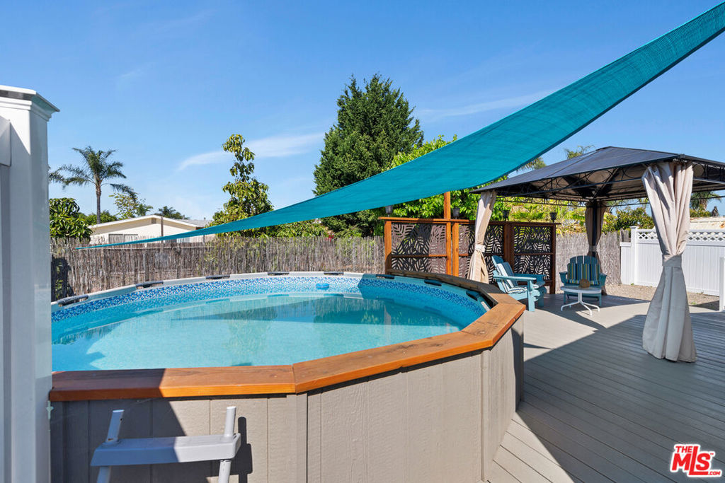 Remodeled Private Pool Home in the most desirable 55+ Community in the area & No Space Rent! Enjoy modern living with all systems updated in 2020- central air & heat, plumbing, and roof. This beautifully designer done mobile home features a remodeled kitchen with island with stainless steel appliances and custom cabinets is perfect for someone that likes to cook and entertain. You will find updated bathrooms, and a refreshed laundry room with all appliances included. The living room features soaring ceilings with luxe fixtures. The spacious primary suite boasts a walk-in closet and an ensuite bath adds a touch of luxury. Step through the french doors outside to a private backyard oasis with weather resistant decking, a solar-heated above-ground pool, gazebo, and space for a garden- all designed for maximum relaxation and enjoyment. In addition, a $40,000 buy-in equity share to the community is included in sales price. Move-in ready and packed with upgrades- this is the one!Positioned in a prime location within the Cascades Park, this home offers an unmatched lifestyle with community amenities such as a heated swimming pool, table pool, ping-pong, a well-stocked library, and a vibrant clubhouse hosting numerous events. Pets are allowed but must be approved. HOA fee includes trash, water & cable.