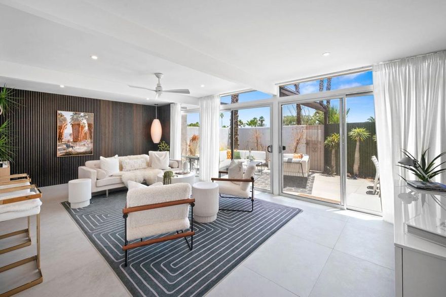1740 N Via Miraleste is a striking mid-century modern condo reimagined with stunning contemporary flair. Featured during the 2024 Modernism Week, this show-stopping home instantly captured attention with its thoughtful design and high-end finishes.This hidden gem has been completely renovated from the ground up, with the transformation completed in December 2023. Every system has been updated for peace of mind -- including newer plumbing, electrical, ductwork, double-pane windows and sliders, a newer electrical panel, tankless water heater, and a newer HVAC unit.Step inside to find a sophisticated blend of clean modern lines and timeless mid-century character. Highlights include custom acoustic wood wall treatments, a one-of-a-kind floating planter, paneled high-end appliances, and a sleek induction cooktop. Thoughtful soundproofing in the walls and ceilings offers serenity and privacy throughout the home.The bathrooms are outfitted with luxurious Kohler 'Components' fixtures and wall-mounted faucets, while the kitchen and baths are finished with custom rift white oak cabinetry. Additional design touches--like George Nelson lighting, a bronze mirrored bar, and playful penny tile accents--add a sense of authenticity and style.The open floor plan is bathed in natural light, with three patios that extend your living space outdoors and capture the desert's indoor-outdoor lifestyle. Enjoy resort-style amenities including two community pools, a spa, and breathtaking views of Mt. San Jacinto.Offered turnkey furnished, this residence is a rare blend of architectural pedigree and modern luxury--ready to enjoy or showcase from day one.