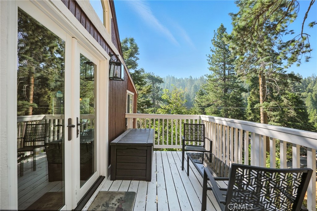 Fully Furnished
This beautifully maintained fully furnished 2-bedroom, 2-bath cabin is available for lease, offering the perfect balance of cozy mountain charm and modern convenience.
Recent upgrades include copper plumbing, a newer roof, a tankless water heater with freeze guard, smart lock entry, Ring security with motion-sensor floodlights, and a 200 AMP electrical panel. Both bathrooms and the kitchen have been tastefully updated with contemporary finishes.
The main level features a full bathroom, a welcoming living room with exposed wood beams and a gas fireplace, a dining area, and a spacious kitchen with skylights and large windows that frame tranquil forest views. Off the kitchen, a refinished wraparound wood deck leads to a fully fenced backyard and BBQ area.
Downstairs, the primary suite includes its own covered porch, ensuite bath, and laundry units. The ensuite provides a spa-like retreat with a clawfoot soaking tub and a picture window overlooking the trees. Upstairs from the main level, the second bedroom offers wood wainscoting and a built-in workspace — ideal for remote work with the property’s lightning-fast WiFi.
Move-in ready and thoughtfully appointed, this fully furnished cabin offers a peaceful setting close to Lake Arrowhead Village shops and restaurants, Snow Valley Ski Resort, hiking trails, and mountain biking routes.