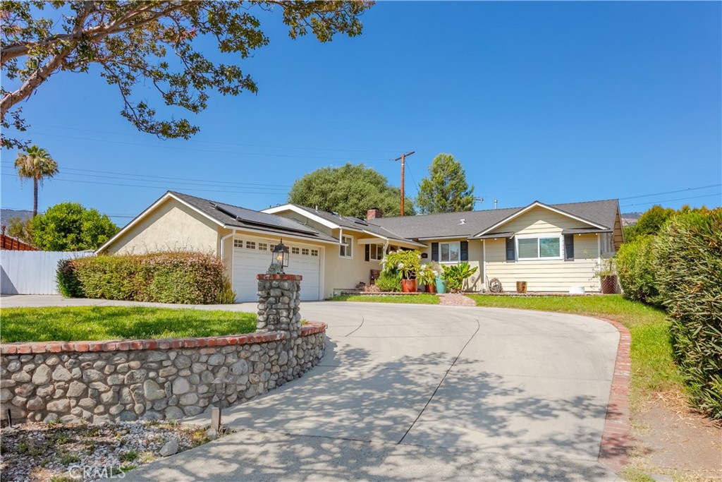 At the quiet end of a North Glendora cul-de-sac, where the foothills frame your view and the pace of life feels just right, you’ll find a home that welcomes you with warmth, character, and thoughtful comfort. 1151 E Mountain View Ave is more than a house—it’s a retreat designed for everyday ease and inspired living.
Step inside and you’re greeted by a sunlit living room, grounded by rich hardwood floors and a charming river rock fireplace—the kind of space that instantly feels like home. Wide sliding glass doors open to a backyard oasis, where entertaining, relaxing, and enjoying the California sun all come naturally.
The kitchen is bright and airy, centered around a skylight that floods the space with soft natural light. Granite countertops, stainless steel appliances, and custom cabinetry make it as functional as it is beautiful. It flows effortlessly into the dining area and cozy family room, creating the ideal setting for casual meals, celebrations, or quiet nights in.
This home features two spacious secondary bedrooms and a generous primary suite that offers privacy and a calming retreat at the end of the day. Each space is designed with light, flow, and functionality in mind.
Behind the scenes, the home is loaded with smart, energy-efficient features that support easy living: 24 fully owned solar panels, dual-pane windows, a high-efficiency HVAC system, LED lighting, new water heater and an attic fan to keep everything cool and efficient throughout the year.
Outdoors, a side yard with a bubbling fountain offers a tranquil escape—and the perfect space for your dream vegetable garden or herbal patch. The backyard itself is expansive and lush, ideal for hosting, playing, or simply enjoying the fresh air. And with a long driveway that fits 4+ additional cars, a 2-car garage, and potential RV parking, there’s no shortage of space for everything you love.
Set in the coveted Glendora Unified School District and just minutes from Glendora Village, this home offers a lifestyle that’s both connected and calm.