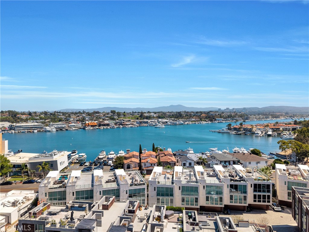 Built in 2019, this premier Newport Beach residence combines modern luxury with panoramic views of the bay, city, and ocean. Featuring 3 bedrooms, 3.5 bathrooms and ~2500 square feet of living space, this home is designed for comfort and style. The entry level includes a two-car garage with extra storage, a large bedroom and bathroom, and elevator access to all floors of the home. The second level hosts two ensuite bedrooms, including a primary suite with unobstructed bay views, a private balcony, an oversized walk-in closet, and a spacious bathroom. The third level features a chef’s kitchen with a large island and walk-in pantry, opening to a bright living area and deck overlooking the water. The rooftop deck with a built-in BBQ offers unmatched 360° views of the community. Additional features include luxury vinyl plank flooring, dual-zone AC, a laundry room, and ample storage throughout. This home sits in a 10/10 location and is seconds away from boutique shopping, waterfront dining, and the water’s edge.