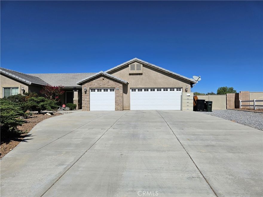 This beautiful 4 bedroom 2 bathroom home is located in a wonderful community on a well maintained street and has lovely curb appeal.  The house boasts 2158 square feet of great living space on a large 18700 square foot lot.  The living room is spacious and has a fireplace with a wood burning stove inside.  The kitchen is perfect for making delicious family meals or special treats for entertaining your guests there is a newer dishwasher and room for an eat in area.  The primary bedroom has a walk-in closet and an attached full bathroom with a spa bathtub.  The additional bedrooms are comfortably sized and the laundry room is conveniently located in the hallway.  There is central air and heat for those warm days and chilly nights.  The back yard has a covered patio and is low maintenance with a couple of fruit bearing trees.  There are 2 garages with space for 3 cars as well as RV parking on the side of the house.   This is a wonderful opportunity to own a beautiful home in Apple Valley.