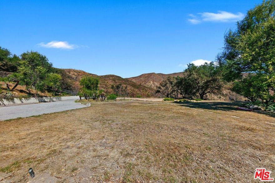 Set in a serene and private pocket of Malibu, these two adjacent parcels, both impacted by the Palisades Fire offer a rare chance to rebuild and reimagine a stunning coastal retreat. Together, they span just over one acre and include an existing pool with ocean and canyon views. The upper parcel, approximately 0.46 acres, previously featured a 3,232 sq. ft. residence with ocean views from the second floor and the potential to rebuild up to 10% larger. The lower parcel, just over 0.5 acres, once held a charming 1,084 sq. ft. home with the same rebuild and expansion opportunity. Whether developed separately or combined to create an estate site. The setting offers exceptional versatility, ideal for creating a main residence with a guest house, studio, or home office on the adjoining lot. A unique Malibu offering with views, privacy, and endless potential to craft your dream coastal sanctuary. For those seeking a true Malibu compound, this property can be purchased together with the adjacent parcel formerly improved with a 4000 sq ft residence, pool, tennis court, and sweeping ocean and mountain views. This offering can be combined to create an unparalleled Malibu compound encompassing approximately three prime acres. Privacy, scale, and unmatched vistas make this a once-in-a-generation opportunity to craft your legacy on the Malibu coastline