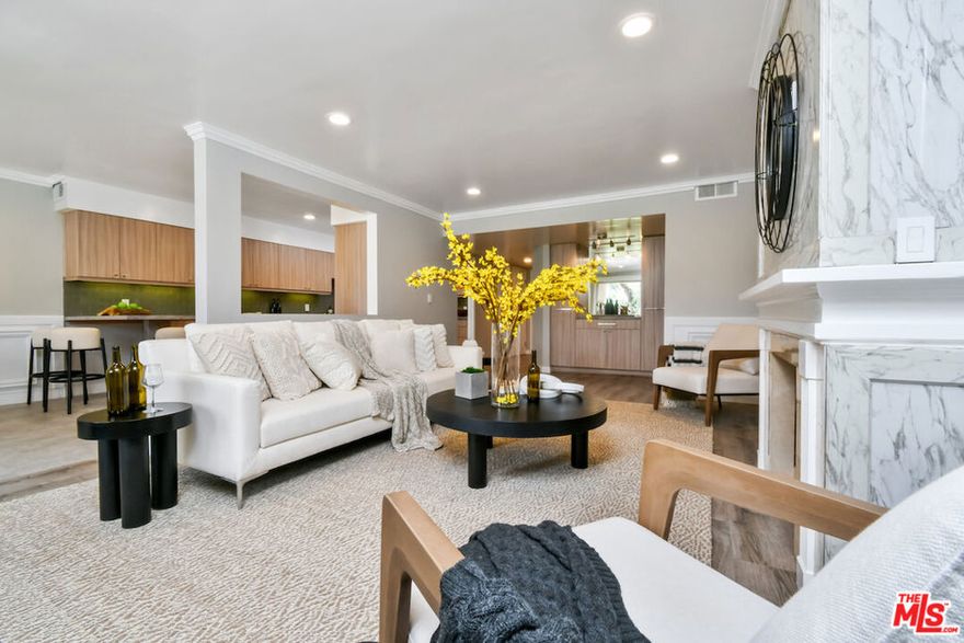 New Price! Absolutely turnkey and beautifully renovated, this single-level, front corner condo is the one you've been waiting for. With a smart, open-concept layout connecting the living room, dining area, and kitchen, it's an entertainer's dream. The inviting living room is anchored by a stylish fireplace, dry bar, and access to a private, east-facing patio; the perfect spot for morning coffee or quiet evenings. Enjoy peaceful views from every window. The cook's kitchen provides stainless steel appliances, abundant warm tone cabinetry and extensive countertops allowing your culinary adventures come to life. Opposite the kitchen, you'll find two spacious bedrooms and two full bathrooms. The primary suite features a walk-in closet and a newly updated bathroom with dual sinks and separate tub and shower. Both bedrooms offer large windows overlooking sun-dappled greenery bringing in gorgeous, filtered light throughout the day. Additional highlights include an in-unit laundry room, no shared walls, abundant storage, parking for two cars in a secure, gated garage and a controlled-access lobby. HOA earthquake insurance for 2025 has been prepaid by Seller. Located within the highly rated Beverly Hills School District and just moments from premier dining, shopping,  La Cienega Park, Beverly Hills Tennis & Pickleball, Restaurant Row, LACMA, The Academy Museum and David Geffen Theater. A truly special home in an unbeatable location.