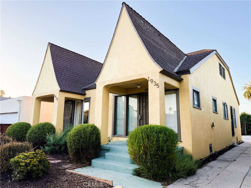 This 1920s Tudor Revival duplex in Jefferson Park blends antique charm with modern upgrades and savvy investment potential, offering two 1-bedroom, 1-bathroom units of approximately 600+ sq ft each (1,218 sq ft combined), delivered vacant at closing. As you arrive, the gated front yard invites you with its beautiful, low-maintenance design—fresh mulch, clean lines, and simple elegance—perfect for enjoying LA’s sunset glow. Unit 1937 welcomes you inside to a spacious living room that flows into a bright, updated kitchen with a sleek island and a cheerful breakfast nook. Behind the main living area, a generously sized bedroom—ideal for a full furniture setup or a home office—is situated next to an upgraded bathroom, with direct access to the side and an expansive backyard, complete with a long driveway that offers ample parking and outdoor space. Unit 1937 has been extensively remodeled with insulated walls, double-pane windows, new drywall and doors, new flooring, updated plumbing and electrical, custom cabinetry, fully renovated kitchen and bath, anti-slip flooring, and a new mini-split heating and cooling system. Meanwhile, Unit 1935 offers a rare blank-slate opportunity—needing some TLC but ready for you to customize your vision. Overall, the property has received fresh paint, a stained wood fence, painted walkways and porch floors, and thoughtfully landscaped yards with mulch, plants, and gravel that ensure low-maintenance enjoyment. Whether you choose to live in one unit and rent the other—or lease both for strong income—this duplex is a rare find with endless potential in one of LA’s most vibrant historic neighborhoods. Located in the heart of Jefferson Park, it’s within walking distance to USC, the Coliseum Stadium, the Expo Transit Line, and the Crenshaw Transit Line, and just minutes from the 10, 110, 101, and 105 freeways. With the 2028 LA Olympics just three years away, this property stands to benefit from surging demand—from short-term rentals tied to Olympic visitors and athletes to long-term appreciation fueled by major infrastructure and transit investments throughout the city.